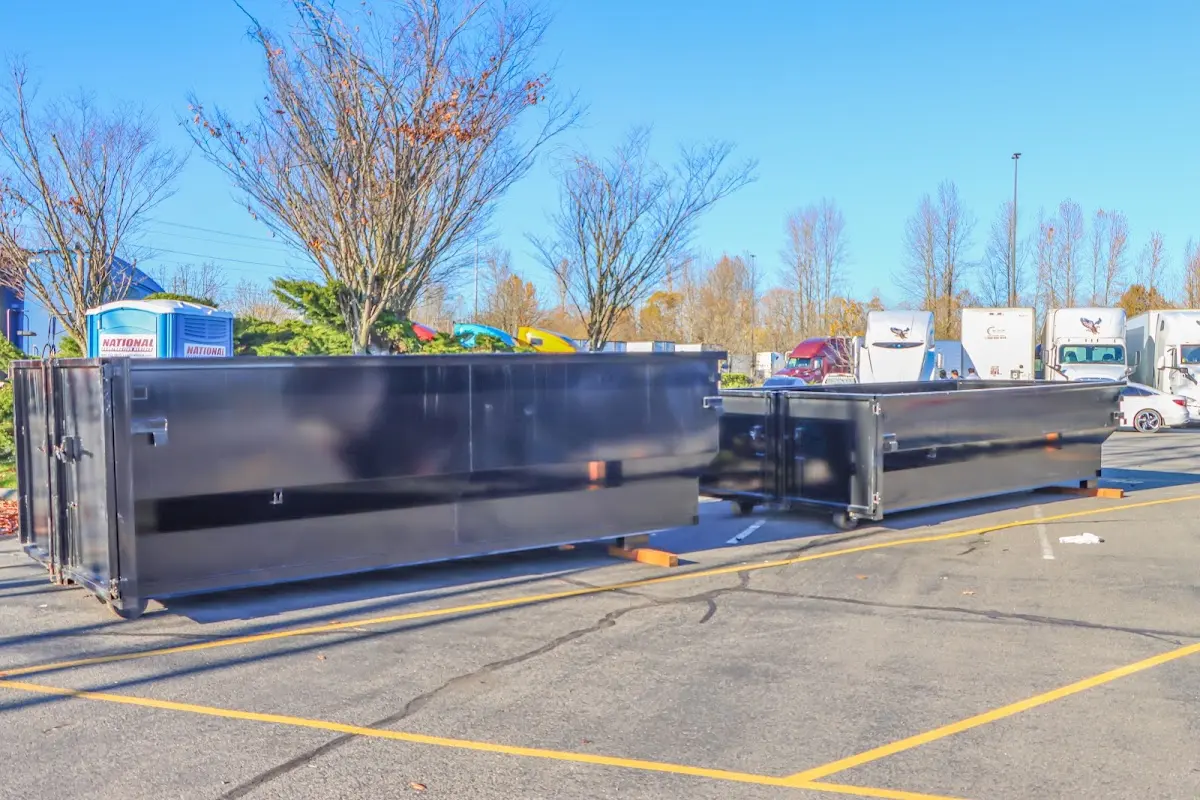 Professional dumpster rental service with roll-off container on residential driveway in Carbondale